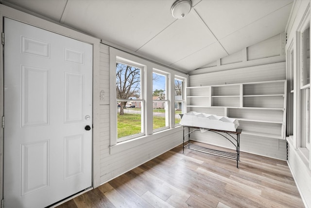 unfurnished sunroom featuring vaulted ceiling