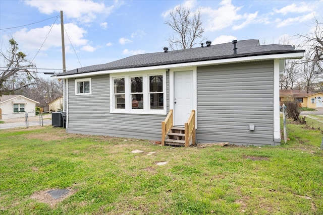 back of property featuring a lawn