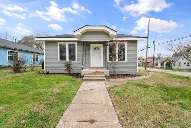 bungalow-style home featuring a front lawn