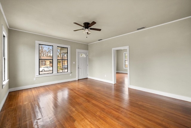 spare room featuring ceiling fan, ornamental molding, and wood-type flooring