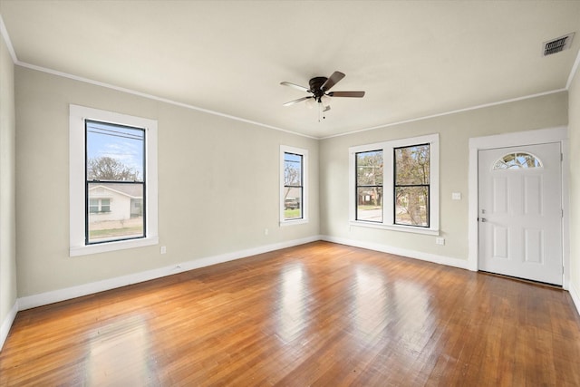 unfurnished room featuring crown molding, wood-type flooring, and ceiling fan