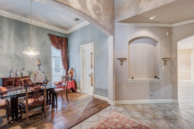 dining area featuring an inviting chandelier and ornamental molding