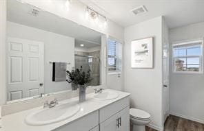 bathroom featuring vanity, toilet, an enclosed shower, and wood-type flooring