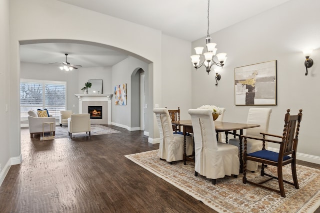 dining space featuring ceiling fan with notable chandelier and hardwood / wood-style floors