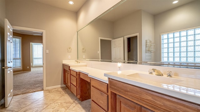 bathroom with tile patterned flooring, vanity, and a wealth of natural light