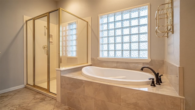 bathroom featuring independent shower and bath