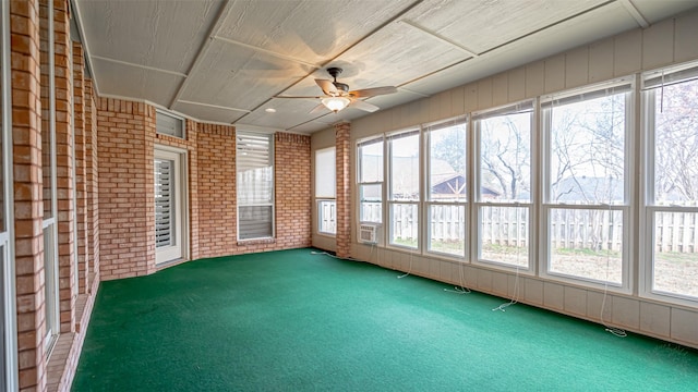 unfurnished sunroom with ceiling fan