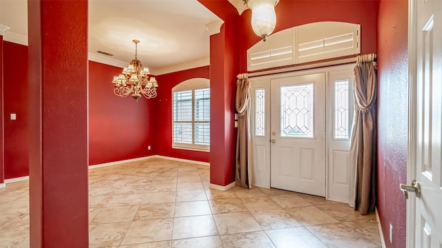 foyer entrance featuring ornamental molding and a chandelier