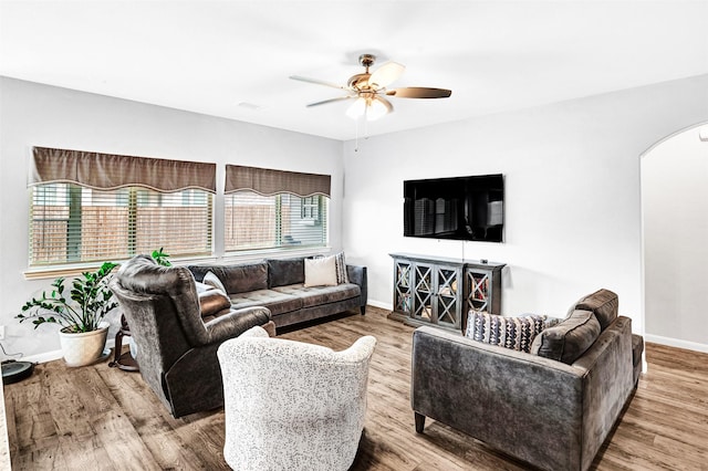 living room featuring wood-type flooring and ceiling fan