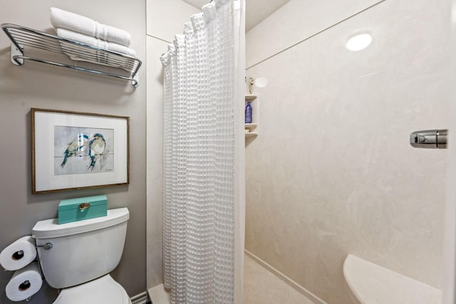 bathroom with a shower with curtain and toilet