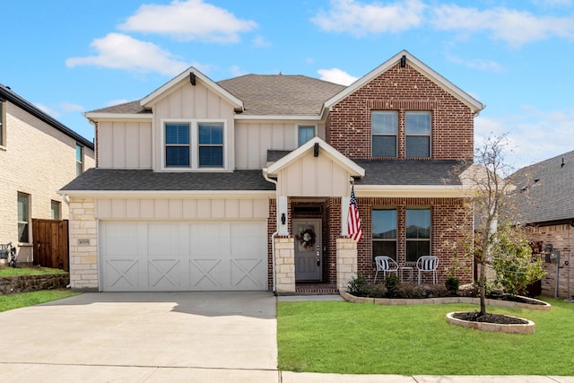 view of front of property featuring a shingled roof, board and batten siding, a front yard, stone siding, and driveway