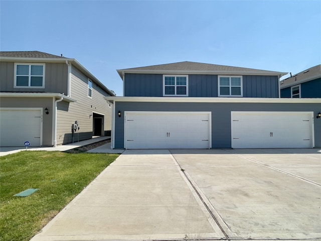 view of front of house with a garage and a front lawn