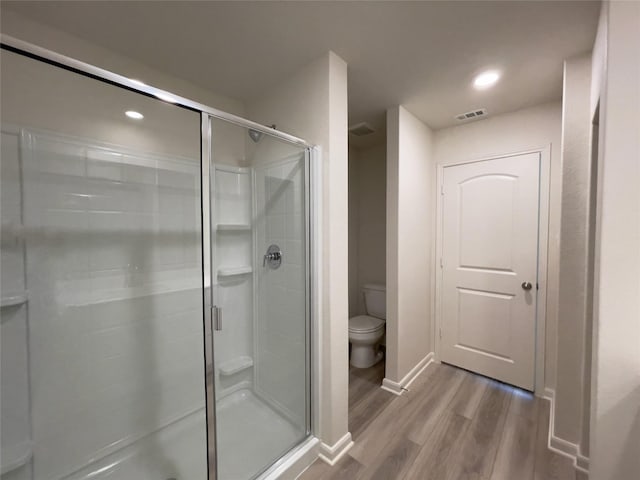 231 Marsh Ln, Princeton, TX 75407 - bathroom with hardwood / wood-style flooring, toilet, and walk in shower