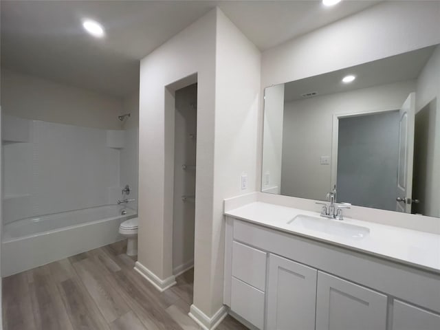 231 Marsh Ln, Princeton, TX 75407 - full bathroom featuring vanity, toilet, bathing tub / shower combination, and hardwood / wood-style floors