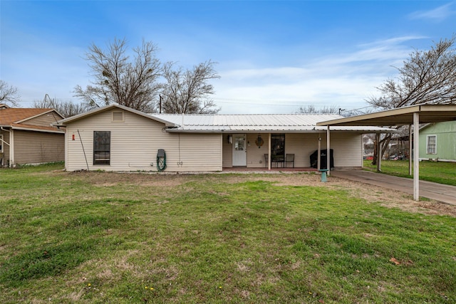 view of front facade with a carport and a front lawn