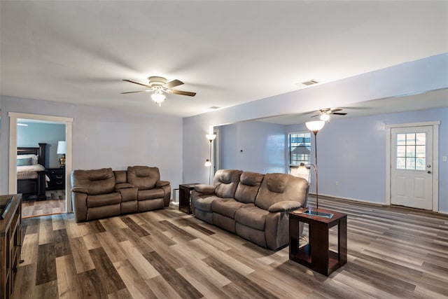 living room featuring hardwood / wood-style flooring and ceiling fan