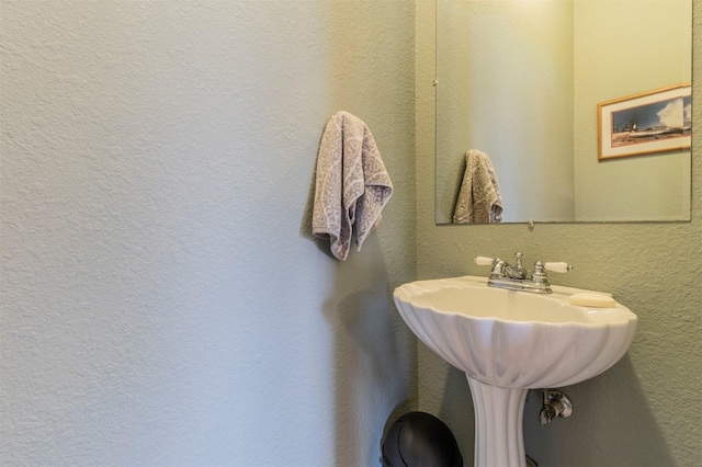 bathroom featuring a textured wall