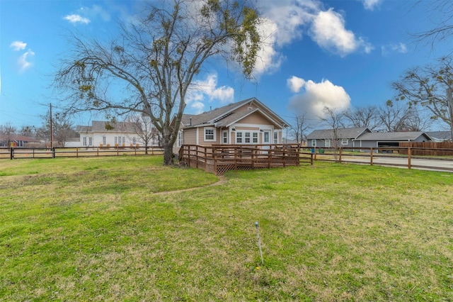 view of yard featuring fence and a wooden deck