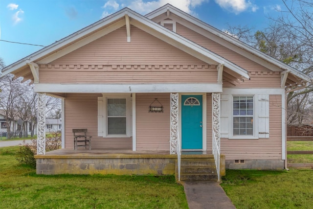 view of front of property with a porch, entry steps, crawl space, and a front lawn