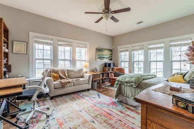 living room featuring ceiling fan, wood finished floors, and visible vents