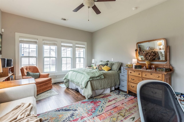 bedroom with visible vents, ceiling fan, and light wood-style flooring