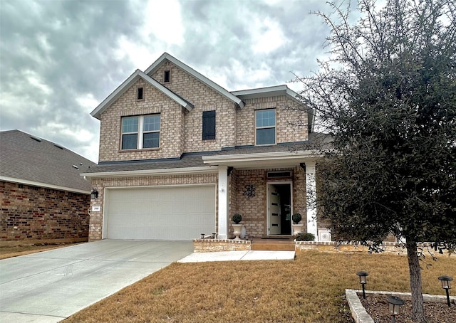 view of front of property with a garage and a front lawn