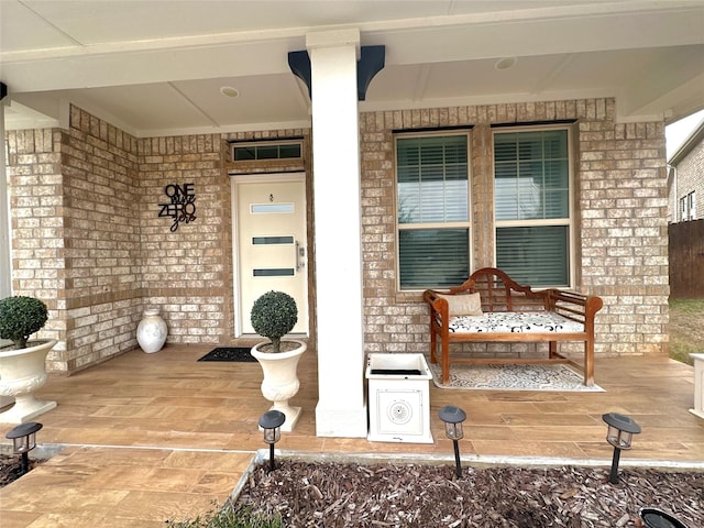 view of exterior entry with a porch