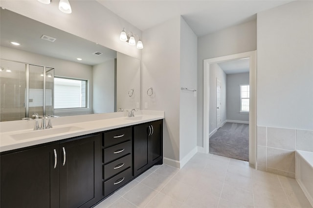 bathroom featuring tile patterned floors, vanity, and independent shower and bath