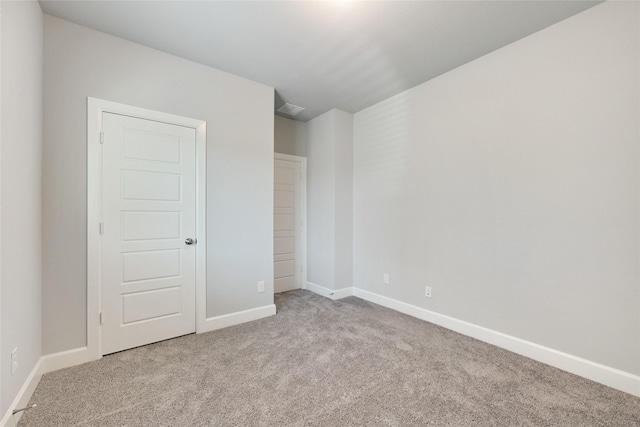 unfurnished bedroom featuring light carpet