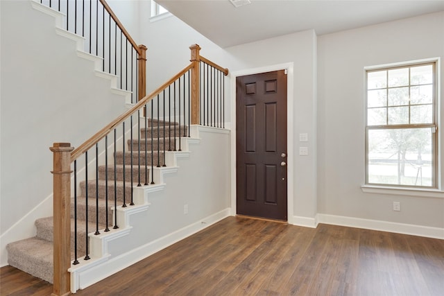 entryway featuring plenty of natural light and dark hardwood / wood-style flooring