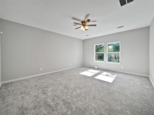 unfurnished room featuring baseboards, visible vents, carpet floors, and ceiling fan