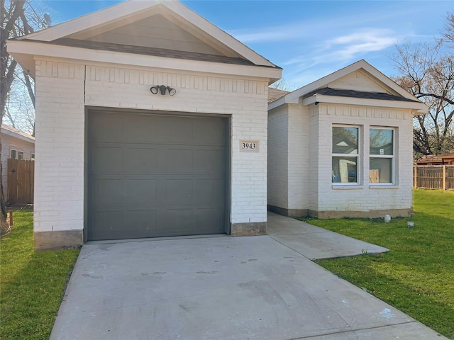 view of front of house with brick siding, driveway, a front yard, and a garage