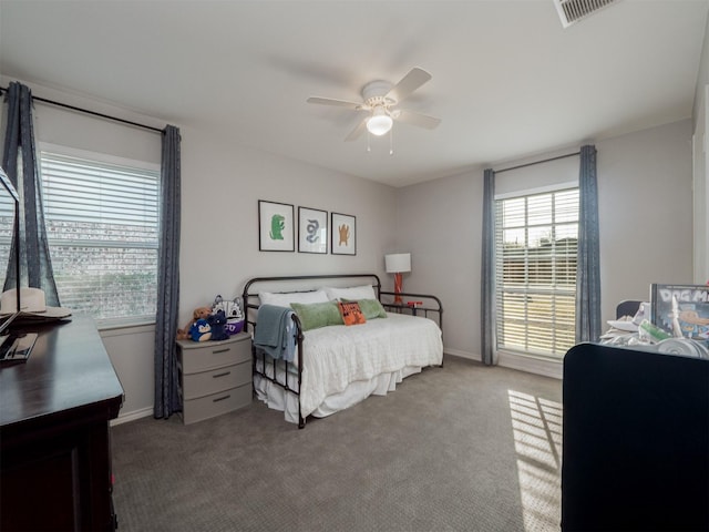 bedroom with ceiling fan, carpet, visible vents, and baseboards