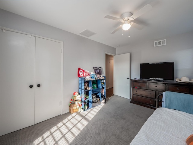 carpeted bedroom with ceiling fan, a closet, and visible vents