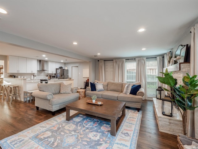 living area featuring dark wood-style floors and recessed lighting