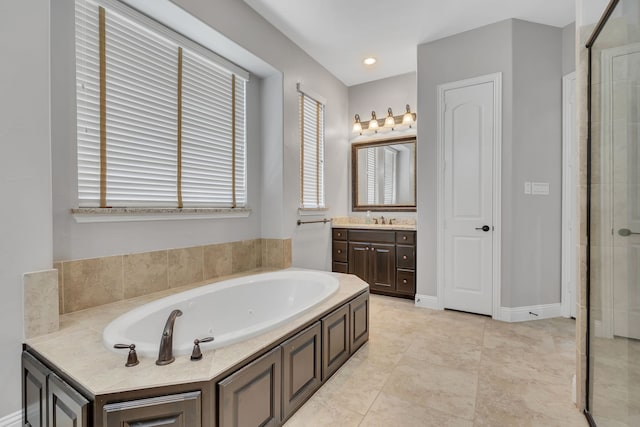 bathroom with a wealth of natural light, vanity, a stall shower, and a tub with jets