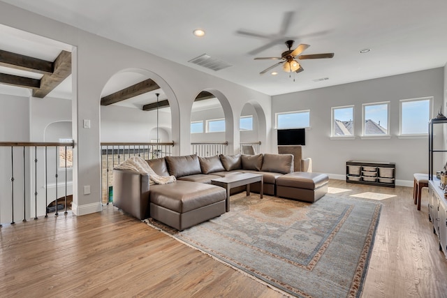 living room featuring light wood finished floors, a ceiling fan, beam ceiling, and recessed lighting