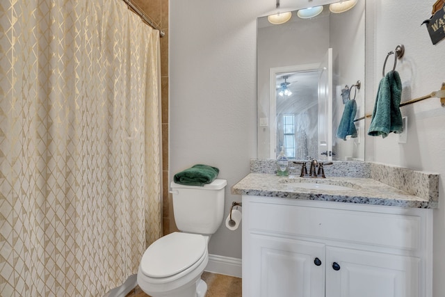 full bathroom featuring curtained shower, vanity, baseboards, and toilet