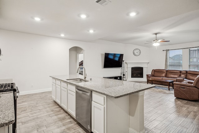 6201 Cheshire St, Celina, TX 76227 - kitchen with sink, white cabinets, stainless steel appliances, light stone countertops, and a center island with sink