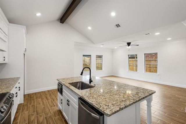 kitchen with dishwasher, white cabinets, range, and an island with sink