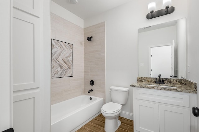 full bathroom with visible vents, toilet, shower / tub combination, wood tiled floor, and vanity