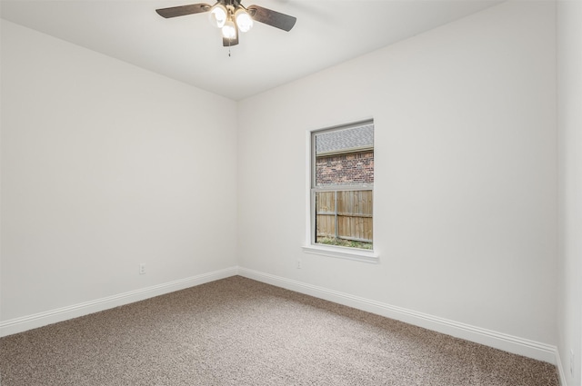 empty room featuring ceiling fan, carpet floors, and baseboards