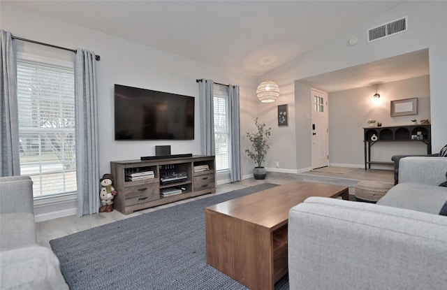 living room with lofted ceiling and light hardwood / wood-style flooring
