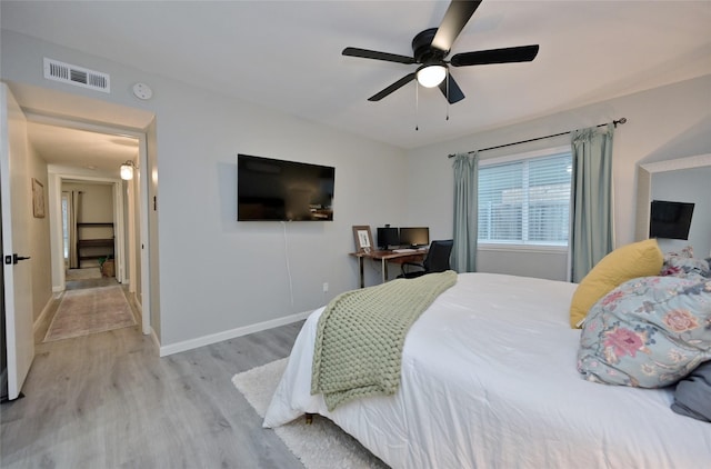 bedroom with ceiling fan and light hardwood / wood-style floors