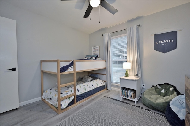 bedroom with ceiling fan, vaulted ceiling, and light wood-type flooring