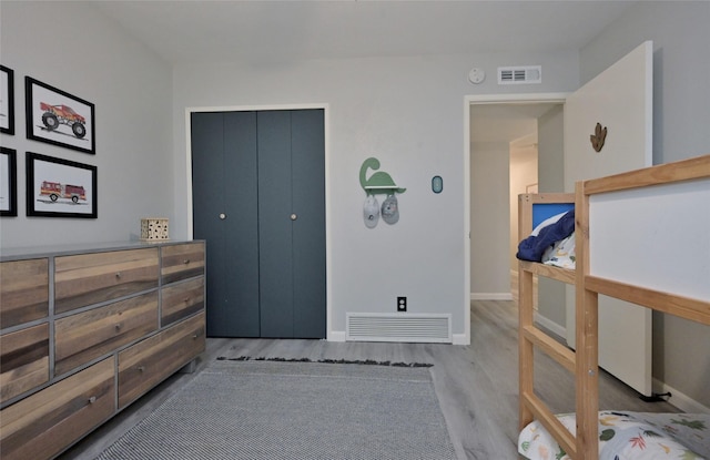bedroom featuring light hardwood / wood-style flooring and a closet