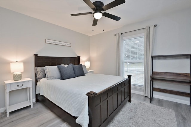 bedroom with light hardwood / wood-style flooring and ceiling fan