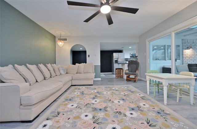 living room featuring ceiling fan and light wood-type flooring