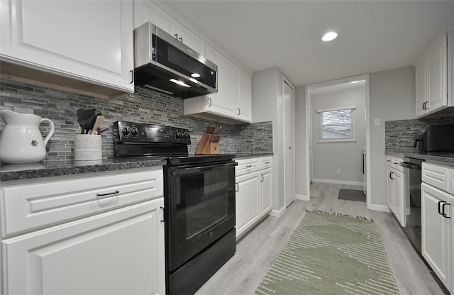 kitchen with tasteful backsplash, black appliances, dark stone countertops, light hardwood / wood-style floors, and white cabinets