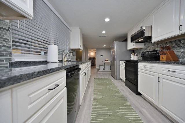 kitchen with tasteful backsplash, white cabinetry, dark stone countertops, and black appliances